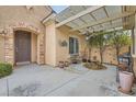 Relaxing outdoor patio area with pergola, brick accents, and a charming water feature at 2385 Orangeburg Pl, Henderson, NV 89044