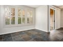 Bright bedroom with shuttered windows and a sliding closet, featuring tile flooring and neutral walls at 251 S Green Valley Pkwy # 4611, Henderson, NV 89012