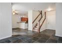 Inviting living area showcases tile flooring, staircase, and seamless transition to the adjacent kitchen at 251 S Green Valley Pkwy # 4611, Henderson, NV 89012