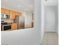 The kitchen boasts stainless steel appliances and flows into the entryway of the home at 2580 Flare Star Dr, Henderson, NV 89044