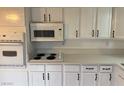 A cozy kitchen with sleek countertops, white cabinetry, and modern appliances at 259 E Van Wagenen St # 259, Henderson, NV 89015