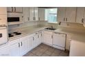 Kitchen with white cabinets and appliances, tile floors, providing a clean and functional cooking area at 259 E Van Wagenen St # 259, Henderson, NV 89015