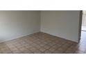 A bright living room with neutral walls and tiled flooring leading to an outdoor patio space at 259 E Van Wagenen St # 259, Henderson, NV 89015