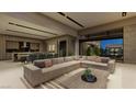 Spacious open-concept living area features a large sectional sofa and gourmet kitchen at 2630 Juniper Branch St, Las Vegas, NV 89117