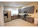 Bright kitchen featuring stainless steel appliances, tile floor and gray cabinets at 4120 E Cincinnati Ave, Las Vegas, NV 89104