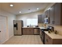 Bright kitchen featuring stainless steel appliances, tile floor and gray cabinets at 4120 E Cincinnati Ave, Las Vegas, NV 89104