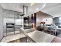 Modern kitchen showcasing stainless steel appliances, integrated lighting, and an open-concept design at 4381 W Flamingo Rd # 1901, Las Vegas, NV 89103