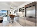 Sleek kitchen featuring stainless steel appliances, marble floors, and a breakfast bar with city views at 4381 W Flamingo Rd # 1903, Las Vegas, NV 89103