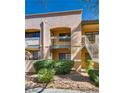 Exterior view of a condo with balconies, stairs, and well-maintained landscaping at 5138 S Jones Blvd # 207, Las Vegas, NV 89118