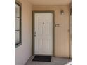 Front door featuring unit number 202 with green trim, a welcome mat, and an outdoor light fixture at 5166 S Jones Blvd # 202, Las Vegas, NV 89118