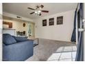 Bright living room with carpeted floors, ceiling fan, and a sliding glass door at 5166 S Jones Blvd # 202, Las Vegas, NV 89118