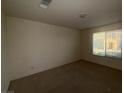 A carpeted bedroom featuring natural light from a window with blinds at 5183 Silica Chalk Ave, Las Vegas, NV 89115