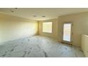 Open living area boasting marble floors and access to the balcony at 5183 Silica Chalk Ave, Las Vegas, NV 89115