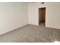 Bright bedroom featuring neutral carpet, white walls, and a doorway leading to an adjacent space at 520 Arrowhead Trl # 1411, Henderson, NV 89015