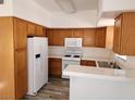 Functional kitchen featuring wood cabinets, white appliances, and a white tile countertop at 520 Arrowhead Trl # 1411, Henderson, NV 89015