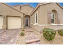 Front entrance with brick paved driveway and entry walkway leading to the front door at 8841 White Harbor Ave, Las Vegas, NV 89148