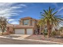 Inviting two-story home featuring a three-car garage, mature landscaping and a beautiful palm tree at 8953 Belconte Ln, Henderson, NV 89074