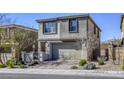 Two-story house showing brick driveway, desert landscaping and beautiful views in the background at 909 Cirrus Cloud Ave, Las Vegas, NV 89138