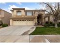 Charming two-story home featuring a spacious three-car garage and well-manicured front yard at 10 Staghorn St, Henderson, NV 89012