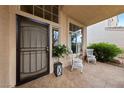 Inviting covered front porch with seating area and decorative tiled flooring at 10 Staghorn St, Henderson, NV 89012