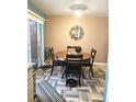 Bright dining area featuring ceramic tile flooring, a round wooden table, and four black chairs at 1079 African Eagle Ave, Henderson, NV 89015