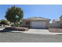 Charming single-story home featuring a two-car garage, desert landscaping, and a tile roof at 1079 African Eagle Ave, Henderson, NV 89015