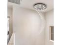 Stairway featuring an elegant crystal spiral chandelier at 11178 Corsica Mist Ave, Las Vegas, NV 89135