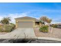 Inviting single-story home with a two-car garage, desert landscaping, and a well-maintained front yard at 2516 Evansville Ave, Henderson, NV 89052