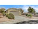 Well-maintained single-story home showcasing a two-car garage, mature trees, and desert landscaping at 2516 Evansville Ave, Henderson, NV 89052