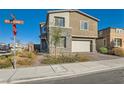 Charming two-story home featuring stone accents, a two-car garage, and landscaped front yard at 290 Mount Tyndall St, Henderson, NV 89015