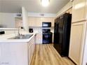 Well-lit kitchen featuring stainless steel sink and black appliances at 3083 Casey Dr # 101, Las Vegas, NV 89120