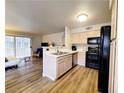 Bright kitchen featuring wood-look floors, stainless steel sink, and modern appliances at 3083 Casey Dr # 101, Las Vegas, NV 89120