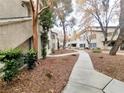 Exterior shot of community showing sidewalks and mature landscaping at 3083 Casey Dr # 101, Las Vegas, NV 89120