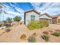 Charming front yard features desert landscaping with a bench next to the sidewalk at 314 Meadow Brush Pl, Henderson, NV 89011