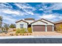 Inviting front exterior with a two car garage, desert landscaping, and beautiful cloudscape at 314 Meadow Brush Pl, Henderson, NV 89011