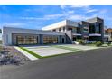 Contemporary home featuring a three-car garage and modern landscaping at 3266 S Spring Mountain Blvd, Pahrump, NV 89048