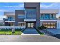 Striking contemporary home showcasing modern design and a unique car display feature at 3266 S Spring Mountain Blvd, Pahrump, NV 89048