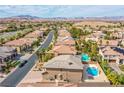 Back of a home in a residential area, showing a pool, spa, and a patio at 4372 Melrose Abbey Pl, Las Vegas, NV 89141