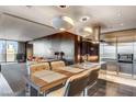 Elegant kitchen with stainless steel appliances, island with bar seating, and a view to the living area at 4381 W Flamingo Rd # 3002, Las Vegas, NV 89103