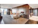 Modern living room boasts wood accent wall, sleek furniture, and city views through large windows at 4381 W Flamingo Rd # 3002, Las Vegas, NV 89103