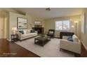 Bright, staged living room with fireplace, hardwood floors, neutral furniture, and natural light at 5345 Silvermist Ct # 203, Las Vegas, NV 89122