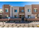 Contemporary townhome showcasing a well-manicured front yard and neutral color scheme at 600 N Carriage Hill Dr # 1020, Las Vegas, NV 89138