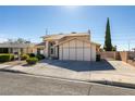 Two-story home showcasing a manicured lawn and ample driveway space at 637 Otono Dr, Boulder City, NV 89005