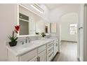 Bright bathroom featuring dual sinks, modern fixtures, and a large mirror at 669 Elliot Peak Ave, Las Vegas, NV 89183