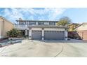Two-story home with a three-car garage and driveway with manicured landscaping and a balcony at 6695 Shadow Cove Ave, Las Vegas, NV 89139
