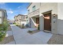 Charming townhome entrance with a decorative wreath, well-manicured landscaping, and a welcoming walkway at 7304 N Decatur Blvd # 6, North Las Vegas, NV 89131