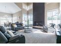 Spacious living room featuring high ceilings, a fireplace, and ample natural light at 8100 Lake Hills Dr, Las Vegas, NV 89128