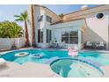 Inviting backyard pool and spa, perfect for relaxing and entertaining, with a view of the home's exterior at 8100 Lake Hills Dr, Las Vegas, NV 89128