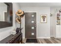 Stylish foyer featuring a modern door, elegant decor, and wood-look flooring at 813 Bonita Ave, Las Vegas, NV 89104