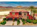 Elegant two-story home boasting a well-manicured lawn, mature trees, and a paved driveway leading to a two-car garage at , Henderson, NV 89011